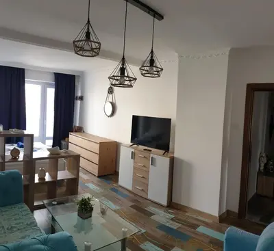 a living room with a couch and a tv at Sunny Seaside Retreat in Burgas in Burgas City