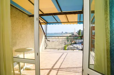a door to a balcony with a view of the ocean at Hotel Star in Sunny Beach