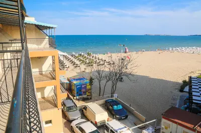 a view of a beach with cars parked next to a building at Hotel Star in Sunny Beach