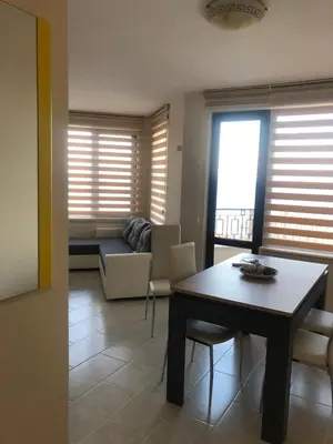 a living room with a table and a couch at Комплекс Рич 2 in Ravda
