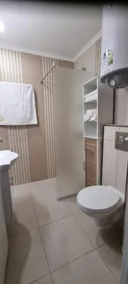 a small bathroom with a toilet and a sink at Balcony Bliss: The Black Sea Pearl in Sveti Vlas