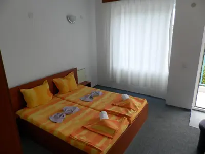 a bedroom with a bed with towels on it at Hotel North in Primorsko