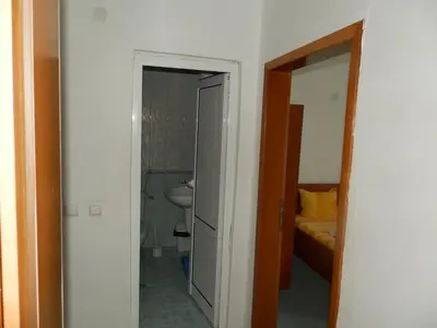 a bathroom with a toilet and a sink in a room at Hotel North in Primorsko