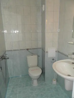 a bathroom with a toilet and a sink at Hotel North in Primorsko