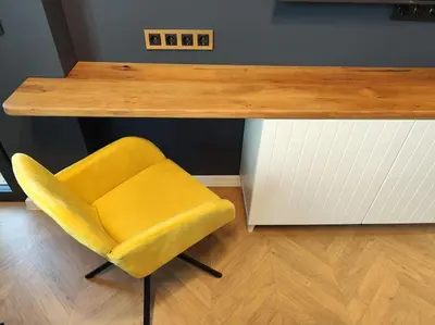 a yellow chair sitting under a table with a counter at TOPAZ Beachfront Apartment in Varna City