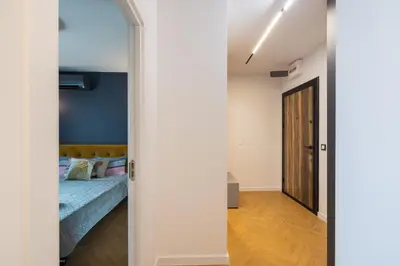 a door leading into a bedroom with a bed at TOPAZ Beachfront Apartment in Varna City