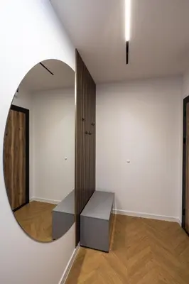 a room with a mirror and a white wall at TOPAZ Beachfront Apartment in Varna City