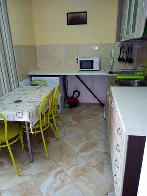 a kitchen with a table and chairs and a microwave at Sea View Apartments in Sozopol