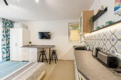 a small kitchen with a bed and a counter at Roman Thermae Central Studio in Varna City