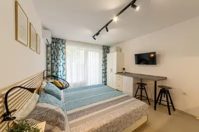 a small bedroom with a bed and a desk at Roman Thermae Central Studio in Varna City