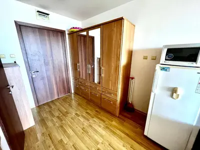 a room with a refrigerator and a door with a microwave at Alexandr apartments Vigo Nesebar in Nesebar