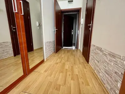 an empty hallway with wooden floors and a door at Alexandr apartments Vigo Nesebar in Nesebar