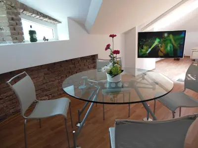a dining room with a glass table and chairs at Florence Studio in Varna City
