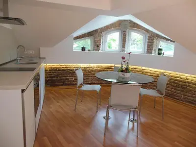 a kitchen and dining room with a table and chairs at Florence Studio in Varna City