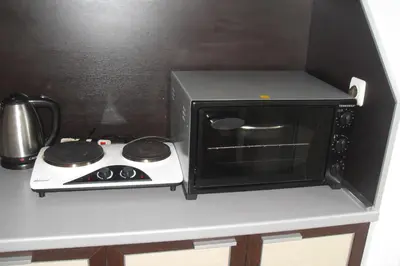 a kitchen with a stove and a microwave on a counter at Kirovi Apartment in Primorsko