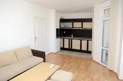 a living room with a couch and a table at Kirovi Apartment in Primorsko