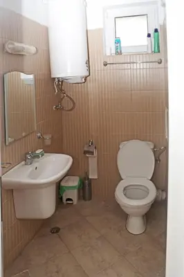 a bathroom with a toilet and a sink at Kirovi Apartment in Primorsko