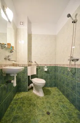 a bathroom with a toilet and a sink at Peneka Hotel in Pomorie