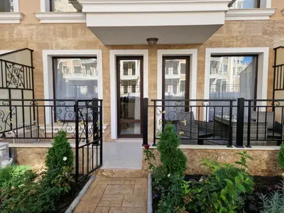 a house with a black wrought iron fence at Polarstar 2-Zimmer Appartements in Sveti Vlas