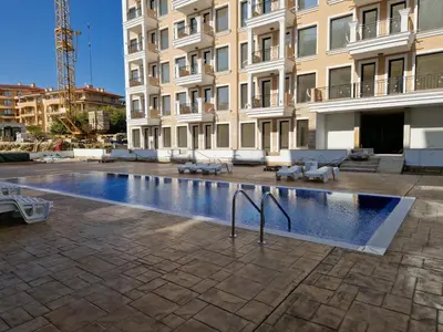 a large swimming pool in front of a building at Polarstar 2-Zimmer Appartements in Sveti Vlas