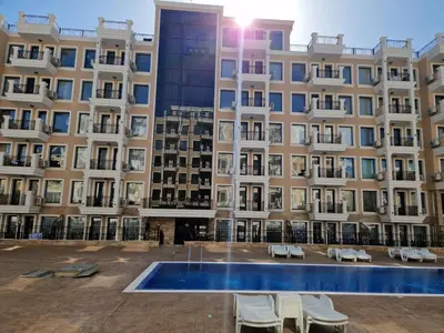 a large building with a swimming pool in front of it at Polarstar 2-Zimmer Appartements in Sveti Vlas