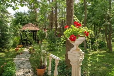 a garden with a vase of flowers on a pole at Hotel Venus in Sunny Beach