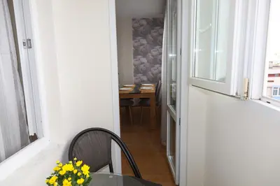 a dining room with a table and a window at Magnolia in Burgas City