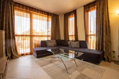 a living room with a couch and a glass table at Kalia apartment in Sunny Beach
