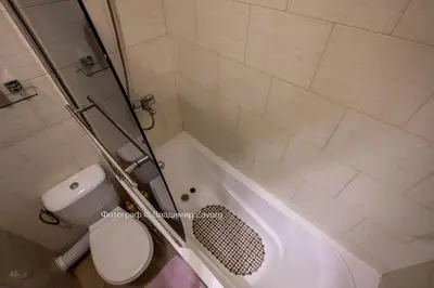 a bathroom with a shower and a toilet and a tub at Kalia apartment in Sunny Beach