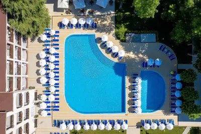 an overhead view of a swimming pool with chairs and umbrellas at Asteria Family Sunny Beach - Ultra All Inclusive in Sunny Beach