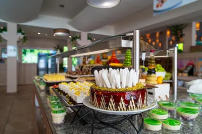 a buffet with cakes and other desserts on display at Asteria Family Sunny Beach - Ultra All Inclusive in Sunny Beach