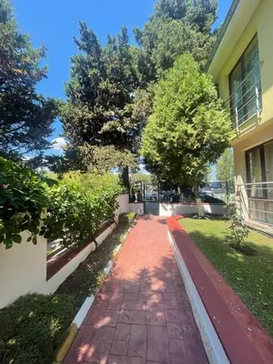 a red brick walkway in front of a building at Aurelia Residences in Ravda