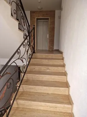 a hallway with stairs with a door in the background at Słoneczny Brzeg Studio Amara in Sunny Beach