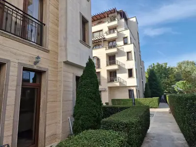 a building with a tree in front of it at Słoneczny Brzeg Studio Amara in Sunny Beach