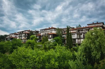 a group of apartment buildings on a hill with trees at Marina Hills in Sozopol