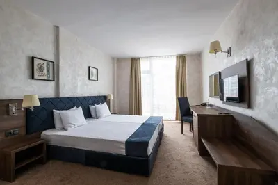 a hotel room with a bed and a desk at Flamingo Beach Hotel in Sunny Beach