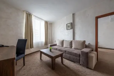 a living room with a couch and a table at Flamingo Beach Hotel in Sunny Beach
