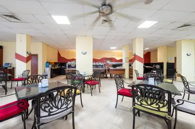 a dining room with tables and chairs in a restaurant at Flamingo Beach Hotel in Sunny Beach