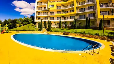 an empty swimming pool in front of a building at William's apartments - sixth large apartment in Sveti Vlas