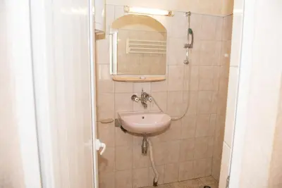 a bathroom with a sink and a mirror at Стаи за гости in Varna City