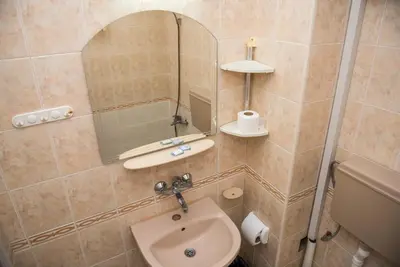 a bathroom with a sink and a mirror at Стаи за гости in Varna City