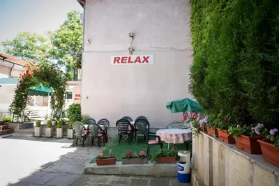 a group of chairs and a table in front of a building at Стаи за гости in Varna City