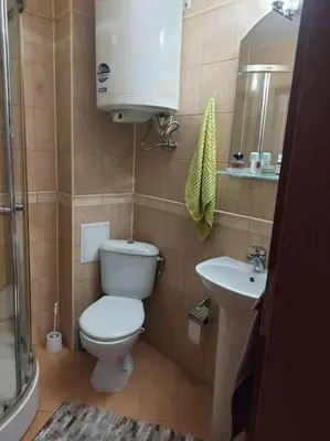 a bathroom with a toilet and a sink at Прекрасные апартаменты с видом на море в центре in Byala