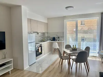 a kitchen and dining room with a table and chairs at AVRORA SUITE in Varna City