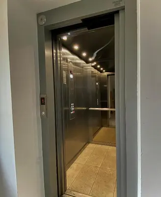 a glass door leading to a hallway in a building at AVRORA SUITE in Varna City