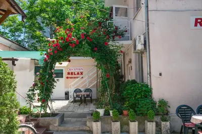 an arch with red flowers on a building at Hotel Relax in Varna City