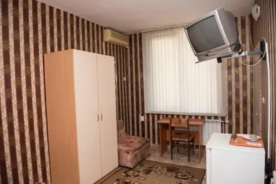 a living room with a tv on the wall at Hotel Relax in Varna City
