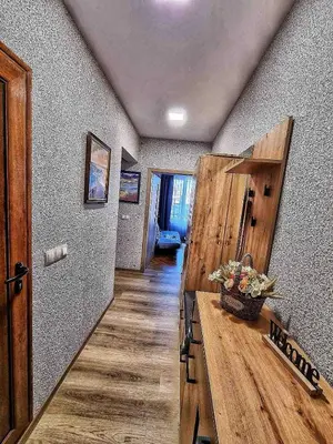 a hallway of a house with a wooden counter and a room at Sea Light in Burgas City