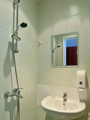 a white bathroom with a sink and a mirror at STELA in Nesebar