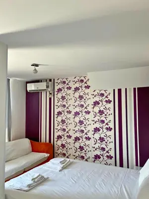 a hotel room with a bed and a couch at STELA in Nesebar